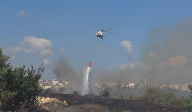 Avcılar’da otluk alanda çıkan yangın helikopter yardımıyla söndürüldü